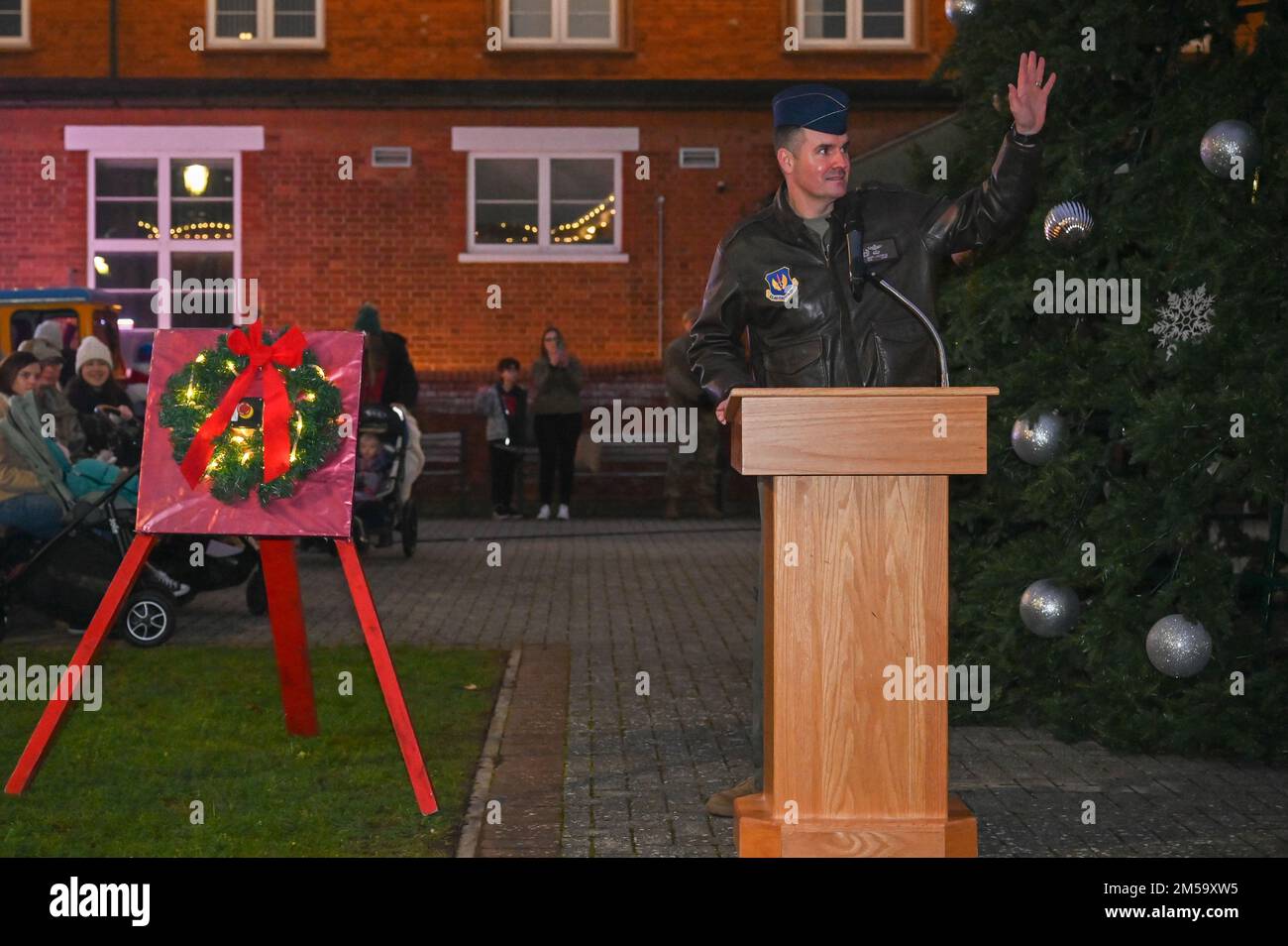 U.S. Air Force Col. Gene Jacobus, 100th Air Refueling Wing commander, speaks to Team Mildenhall families during the annual Christmas tree lighting ceremony Dec. 1, 2022, at Royal Air Force Mildenhall, England. It's a base tradition for the 100th ARW commander to light the tree each year. Stock Photo