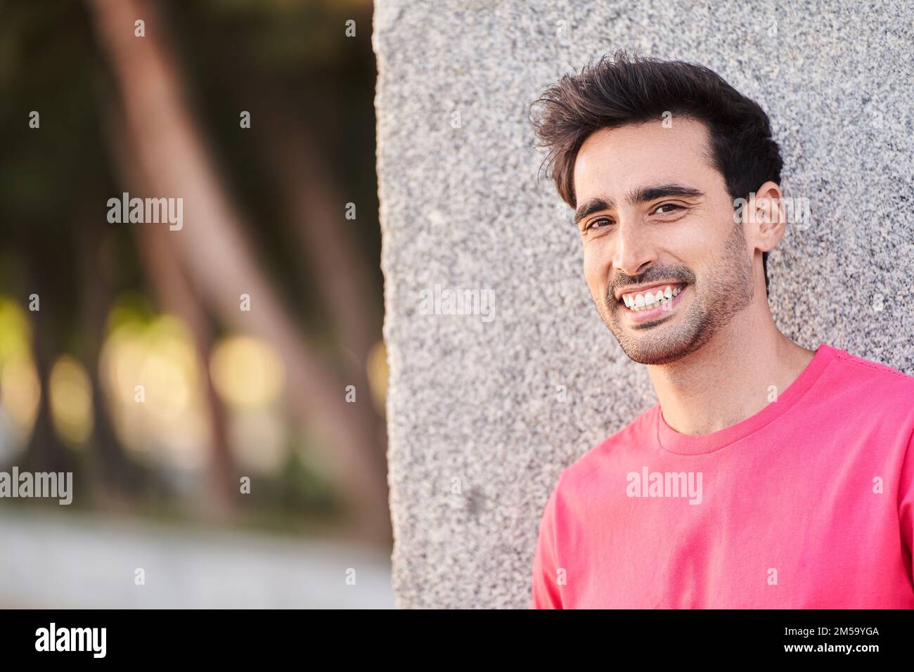 Portrait of a smiling young man. Close up outside shot of happy gorgeous guy. High quality photo Stock Photo