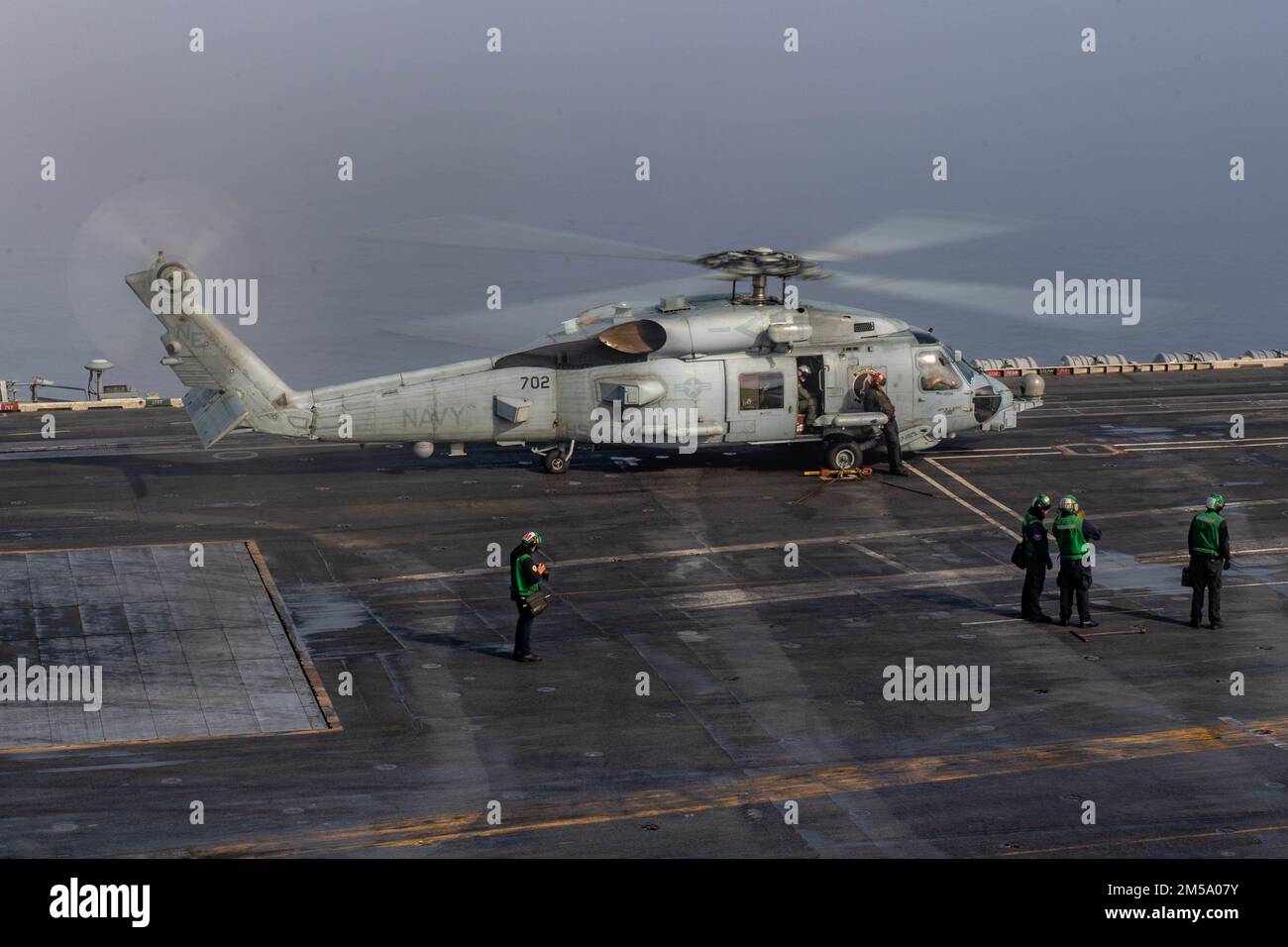 220213-N-YN807-1099 PACIFIC OCEAN (Feb. 13, 2022) An MH-60R Sea Hawk, assigned to the “Blue Hawks” of Helicopter Maritime Strike Squadron (HSM) 78, prepares to take off from the flight deck of Nimitz-class aircraft carrier USS Carl Vinson (CVN 70), Feb. 13, 2022. Vinson is currently conducting routine maritime operations in U.S. 3rd Fleet. Stock Photo