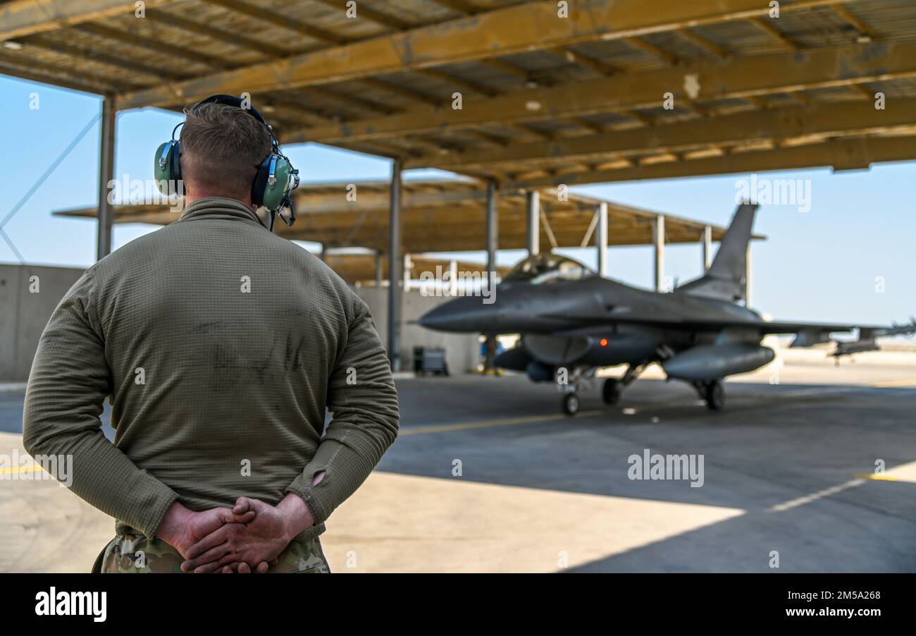 U.S. Air Force Airman 1st Class Trace Cannon, 378th Expeditionary Maintenance Squadron crew chief, conducts pre-flight checks for an F-16 Fighting Falcon at King Abdulaziz Air Base, Kingdom of Saudi Arabia, Feb. 13, 2022. Training with partner nations strengthens military-to-military relationships, improves interoperability and promotes regional stability. Stock Photo
