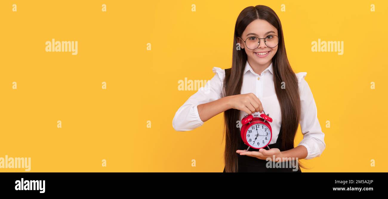 happy nerd child with alarm clock. school kid in uniform and glasses ...
