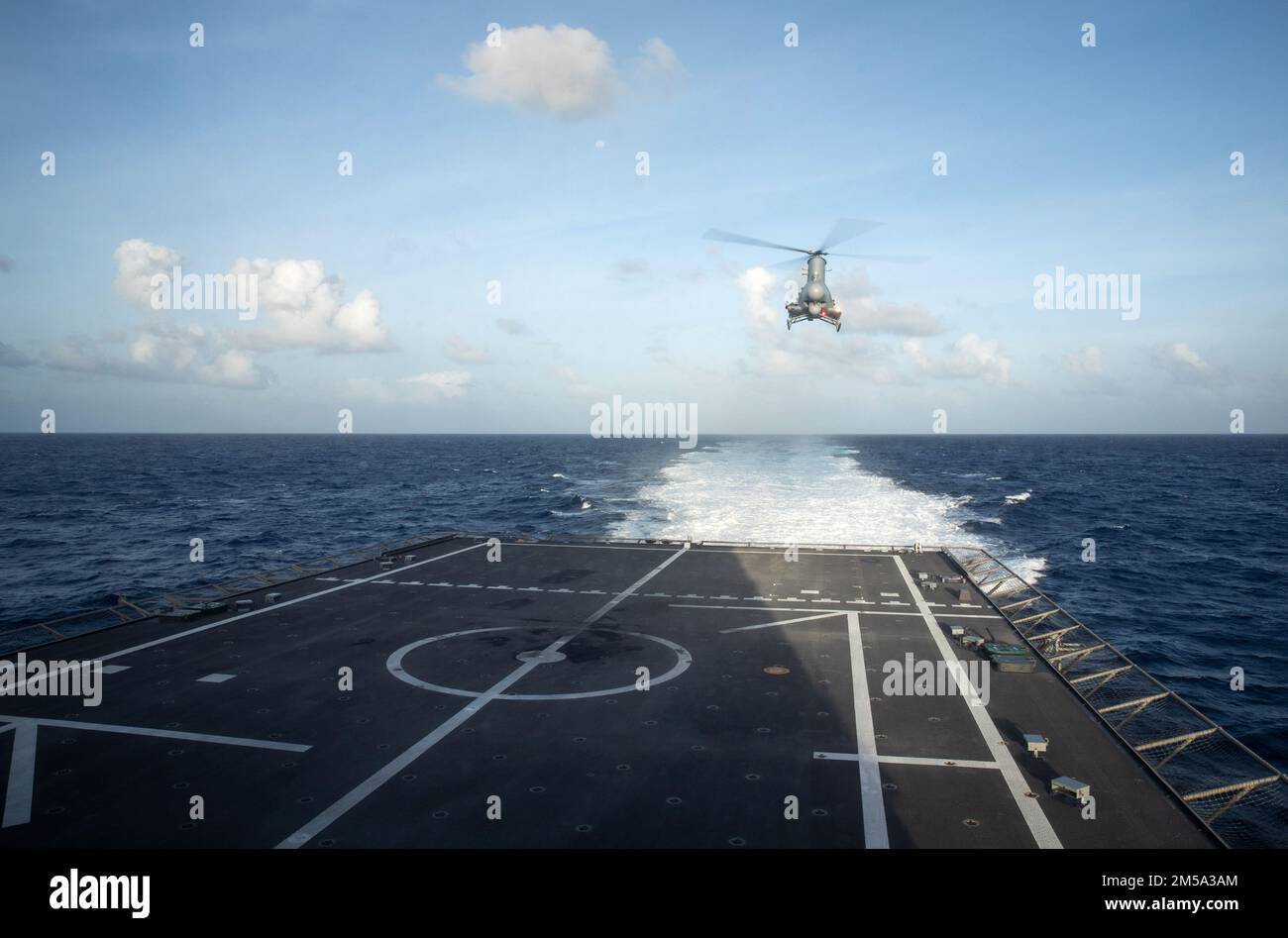220214-N-LI768-1121  PHILIPPINE SEA (Feb. 14, 2022) – An MQ-8B Fire Scout hovers over the flight deck of the Independence-variant littoral combat ship USS Tulsa (LCS 16). Tulsa, part of Destroyer Squadron (DESRON) 7, is on a rotational deployment, operating in the U.S. 7th Fleet area of operations to enhance interoperability with partners and serve as a ready-response force in support of a free and open Indo-Pacific region. Stock Photo