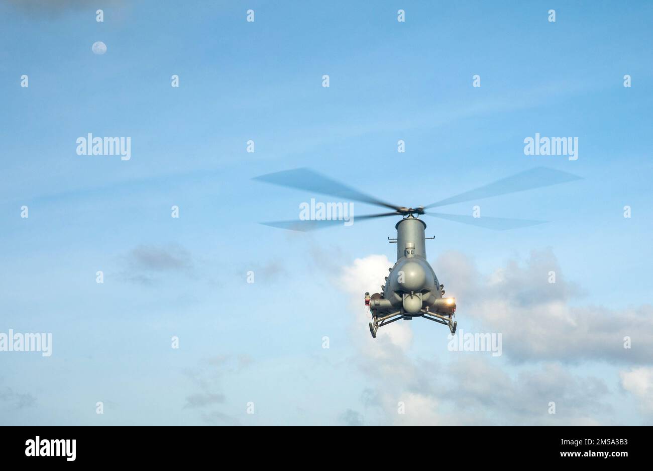220214-N-LI768-1123  PHILIPPINE SEA (Feb. 14, 2022) – An MQ-8B Fire Scout hovers over the flight deck of the Independence-variant littoral combat ship USS Tulsa (LCS 16). Tulsa, part of Destroyer Squadron (DESRON) 7, is on a rotational deployment, operating in the U.S. 7th Fleet area of operations to enhance interoperability with partners and serve as a ready-response force in support of a free and open Indo-Pacific region. Stock Photo