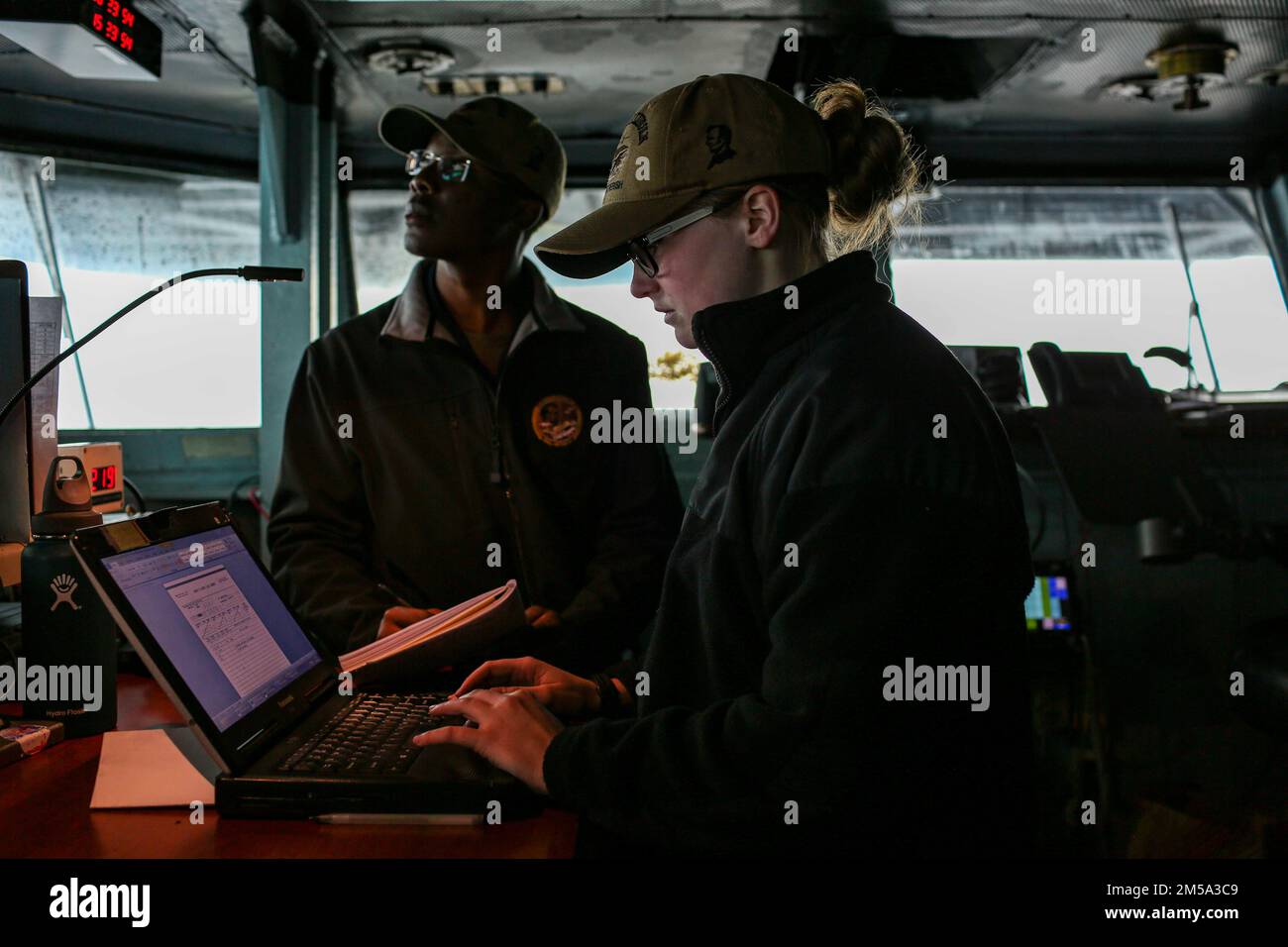 PHILIPPINE SEA (Feb. 14, 2022) Quartermaster Seaman Dakota Barnett, from Yuma, Ariz., makes a deck log entry on the bridge aboard the Nimitz-class aircraft carrier USS Abraham Lincoln (CVN 72). Abraham Lincoln Strike Group is on a scheduled deployment in the U.S. 7th Fleet area of operations to enhance interoperability through alliances and partnerships while serving as a ready-response force in support of a free and open Indo-Pacific region. Stock Photo