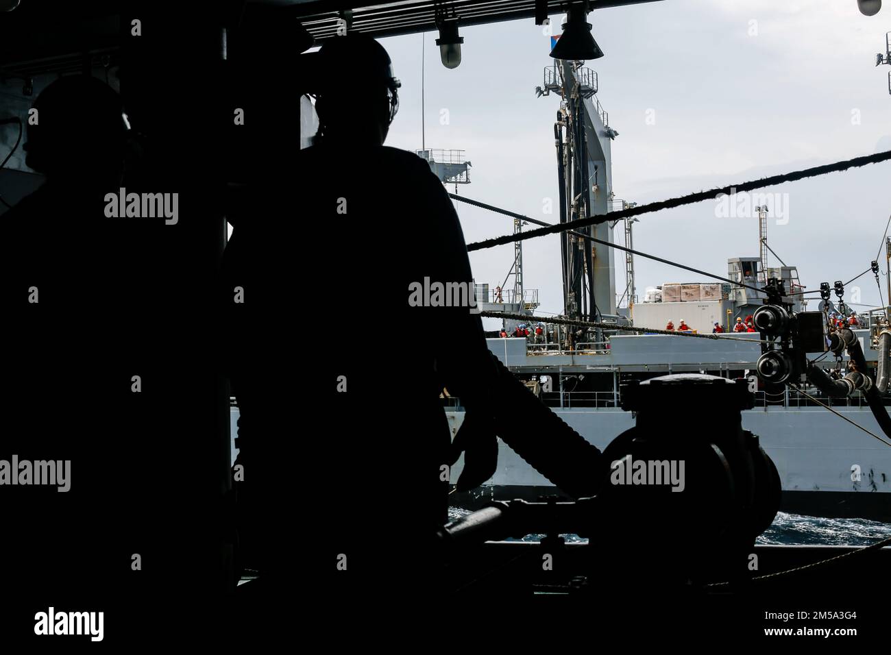 PHILIPPINE SEA (Feb. 14, 2022) Sailors aboard the Nimitz-class aircraft carrier USS Abraham Lincoln (CVN 72) prepare for a fueling-at-sea with the Military Sealift Command fleet replenishment oiler USNS Yukon (T-AO 202). Abraham Lincoln Strike Group is on a scheduled deployment in the U.S. 7th Fleet area of operations to enhance interoperability through alliances and partnerships while serving as a ready-response force in support of a free and open Indo-Pacific region. Stock Photo