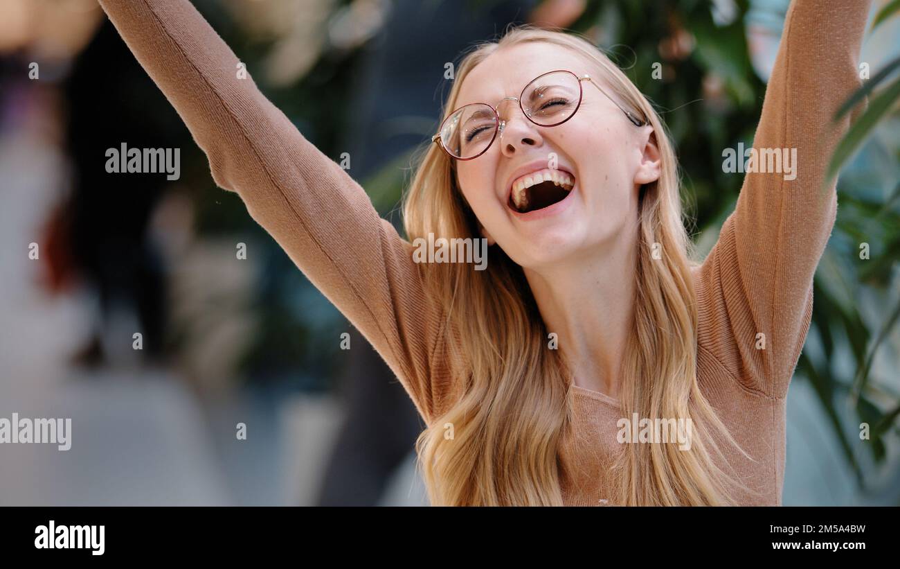 Happy euphoric young woman excited receive good news long awaited email message lady won lottery winner looking at phone cheerful girl celebrating Stock Photo