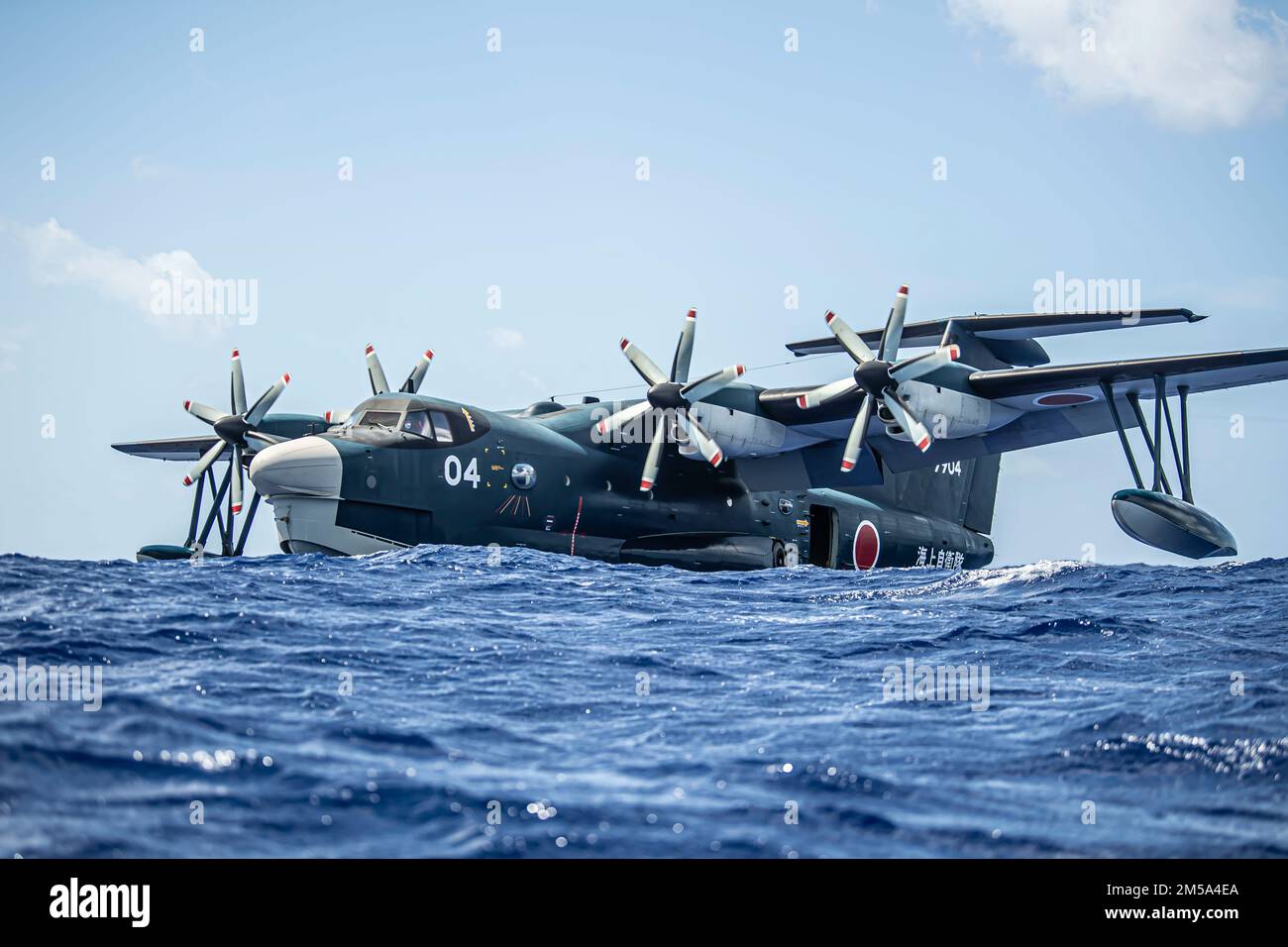 A Japanese ShinMaywa US-2 floats in the ocean during exercise Cope North 22 at the Island of Tinian near Andersen Air Force Base, Guam, Feb. 14, 2022. Japanese and U.S. Air Force members trained together in participation of Cope North 2022, multilateral U.S. Pacific Air Forces-sponsored field training exercise conducted annually at Andersen AFB, Guam focused on combat air forces’ large-force employment and humanitarian assistance and disaster relief training to enhance interoperability among U.S., Australian, and Japanese forces. Stock Photo