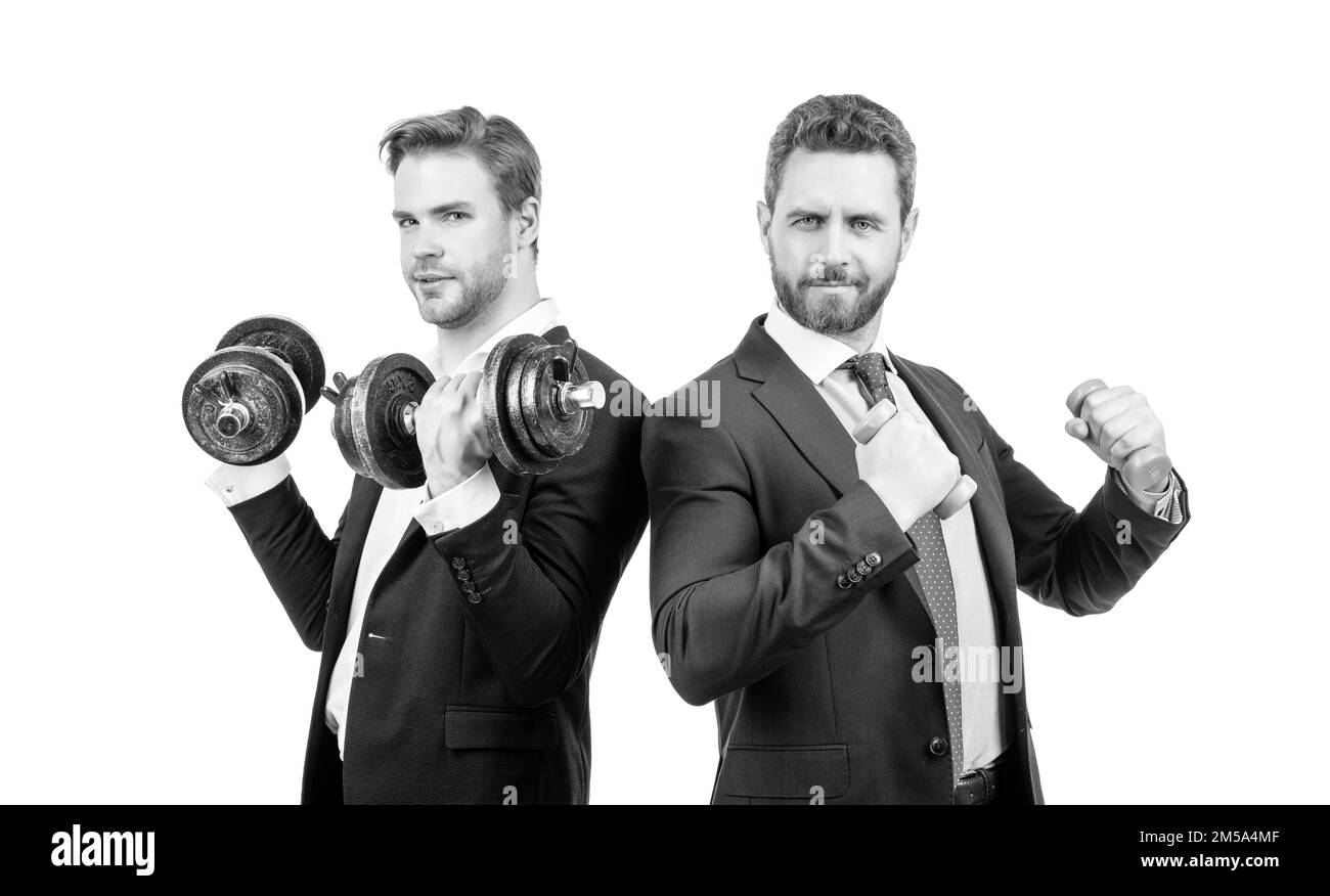 Strong and weak businessmen do dumbbell workout with hand weights, business competition Stock Photo