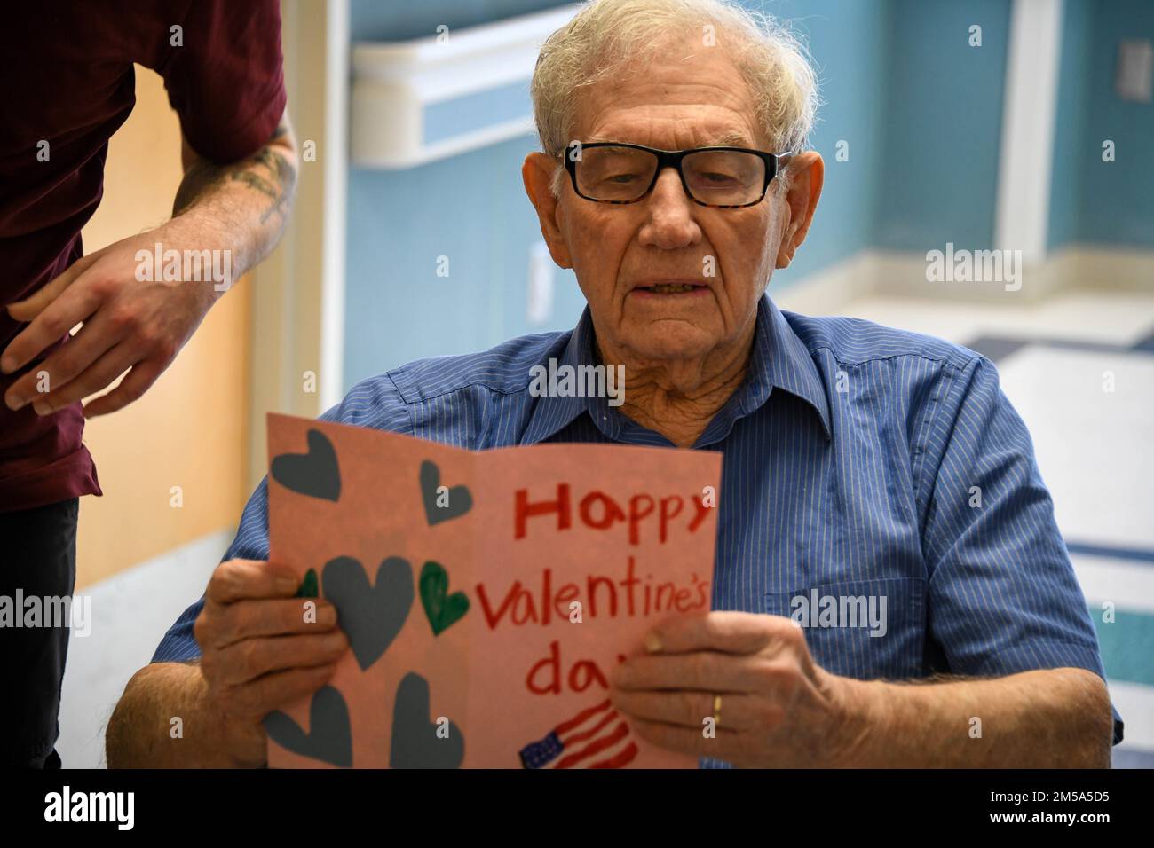 A veteran reads a Valentine’s Day card at the Clinton Veterans Center