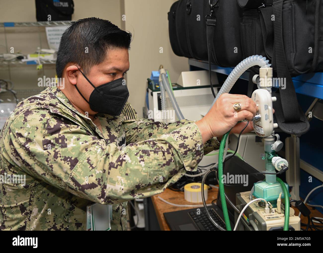 220215-N-UJ449-1013 NAVAL AIR STATION SIGONELLA, Italy (Feb. 15, 2022)— Hospital Corpsman 1st Class Victoriano Rosales, from San Diego, assigned to U.S. Navy Medicine and Readiness Training Command Sigonella, performs maintenance on a portable ventilator on Naval Air Station Sigonella, Feb. 15, 2022. NAS Sigonella’s strategic location enables U.S., allied, and partner nation forces to deploy and respond as required, ensuring security and stability in Europe, Africa and Central Command. Stock Photo
