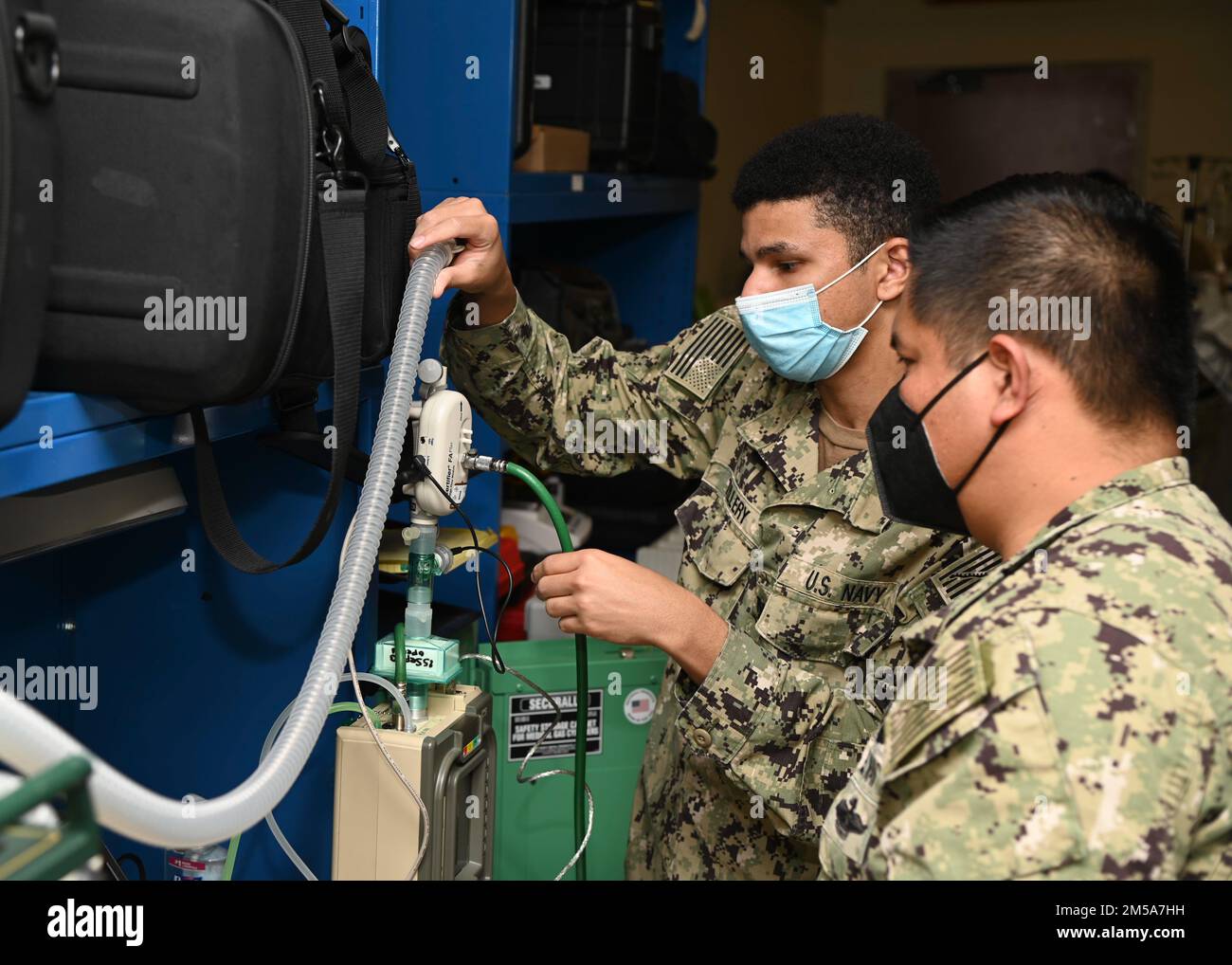 220215-N-UJ449-1018 NAVAL AIR STATION SIGONELLA, Italy (Feb. 15, 2022)— Hospital Corpsman 1st Class Victoriano Rosales, from San Diego, (right) and Hospital Corpsman 3rd Class Demetrius Tillery, from New York City, both assigned to U.S. Navy Medicine and Readiness Training Command Sigonella, perform maintenance on a portable ventilator on Naval Air Station Sigonella, Feb. 15, 2022. NAS Sigonella’s strategic location enables U.S., allied, and partner nation forces to deploy and respond as required, ensuring security and stability in Europe, Africa and Central Command. Stock Photo