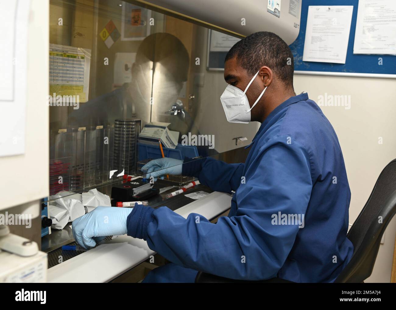 220215-N-UJ449-1021 NAVAL AIR STATION SIGONELLA, Italy (Feb. 15, 2022)— Hospitalman Devonta Johnson, from Lafayette, La., assigned to U.S. Navy Medicine and Readiness Training Command Sigonella, prepares COVID-19 swabs for testing on Naval Air Station Sigonella, Feb. 15, 2022. NAS Sigonella’s strategic location enables U.S., allied, and partner nation forces to deploy and respond as required, ensuring security and stability in Europe, Africa and Central Command. Stock Photo