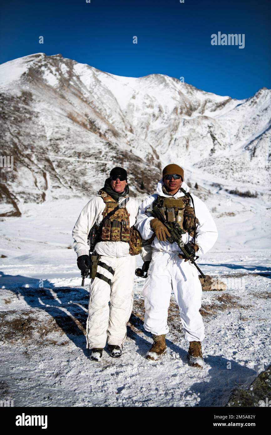 A U.S. Army paratrooper assigned to the 173rd Airborne Brigade stands together with an Italian soldier from the 3rd Alpini Regiment after ascending a mountain during an integrated field training exercise. This training is part of Exercise Steel Blizzard at Pian dell’Alpe in Usseaux, Italy on Feb. 15, 2022.    Exercise Steel Blizzard is an Italian Army-hosted multinational mountain and arctic warfare training exercise. Three reconnaissance platoons from the 173rd Airborne Brigade take part in a three-phase training regimen with the 3rd Alpini Regiment to expand force capabilities by learning ho Stock Photo