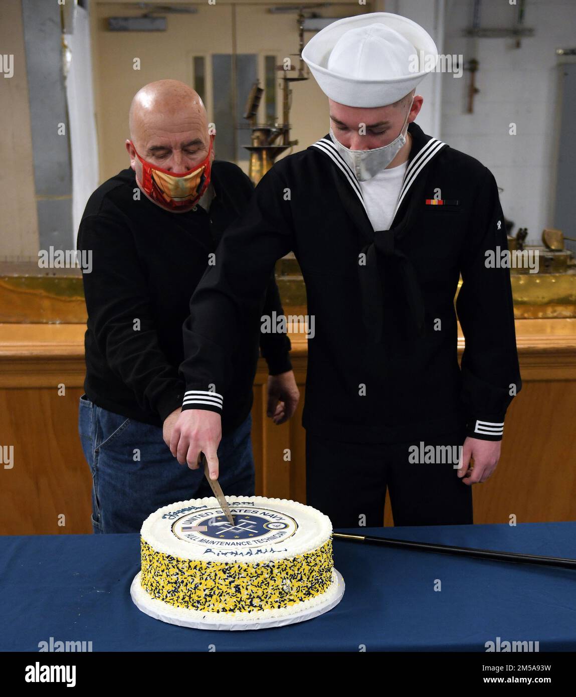 220215-N-JU575-1604 GREAT LAKES, Ill. (Feb. 15, 2022) Guest speaker retired Hull Maintenance Technician 1st Class Frank Yontz and Hull Maintenance Technician Fireman Nicholas A. Ezzek from Surface Warfare Engineering School Command Great Lakes cut a cake celebrating the rate's 50th birthday. During the ceremony staff and students at the Hull Maintenance Technician (HT) 'A' School hear about the history of rate and to pay tribute to the heroics of past and present HTs. Stock Photo