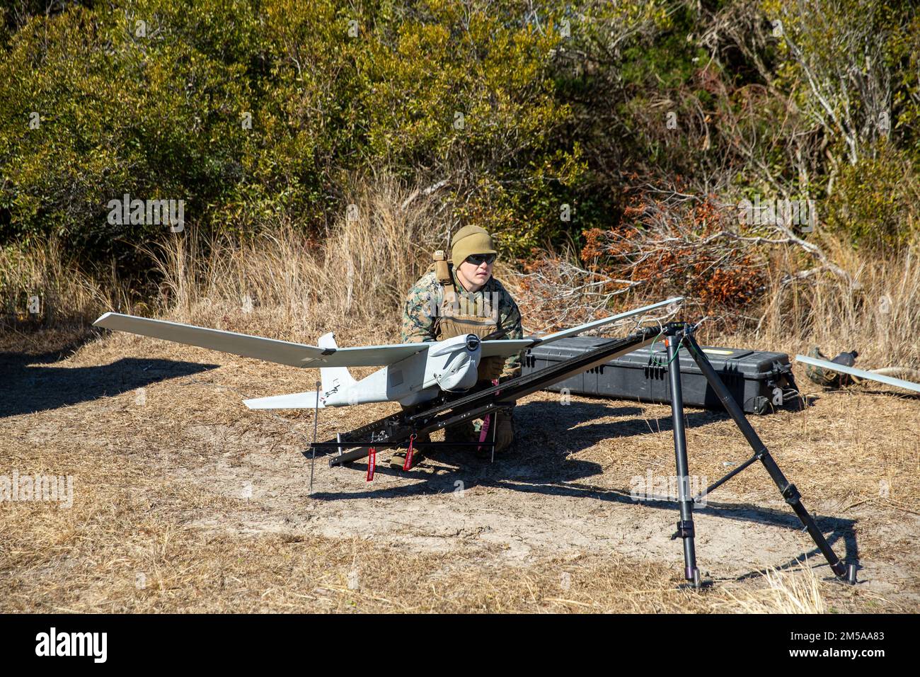 U.S. Marine Corps Pfc. Cameron Nelson, a native of Houston, Texas, and a field artillery cannoneer with 1st Battalion, 10th Marine Regiment, 2d Marine Division, prepares to launch a RQ-20 Puma during a littoral fire exercise on Camp Lejeune, North Carolina, Feb. 15, 2022. The exercise included shore-to-ship fires in order to test the viability of traditional artillery being used to engage maritime targets offshore. Stock Photo