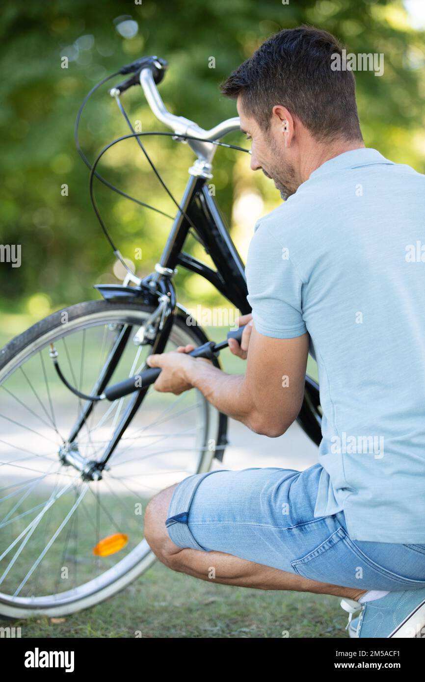 pumping up bike tyres with hand pump