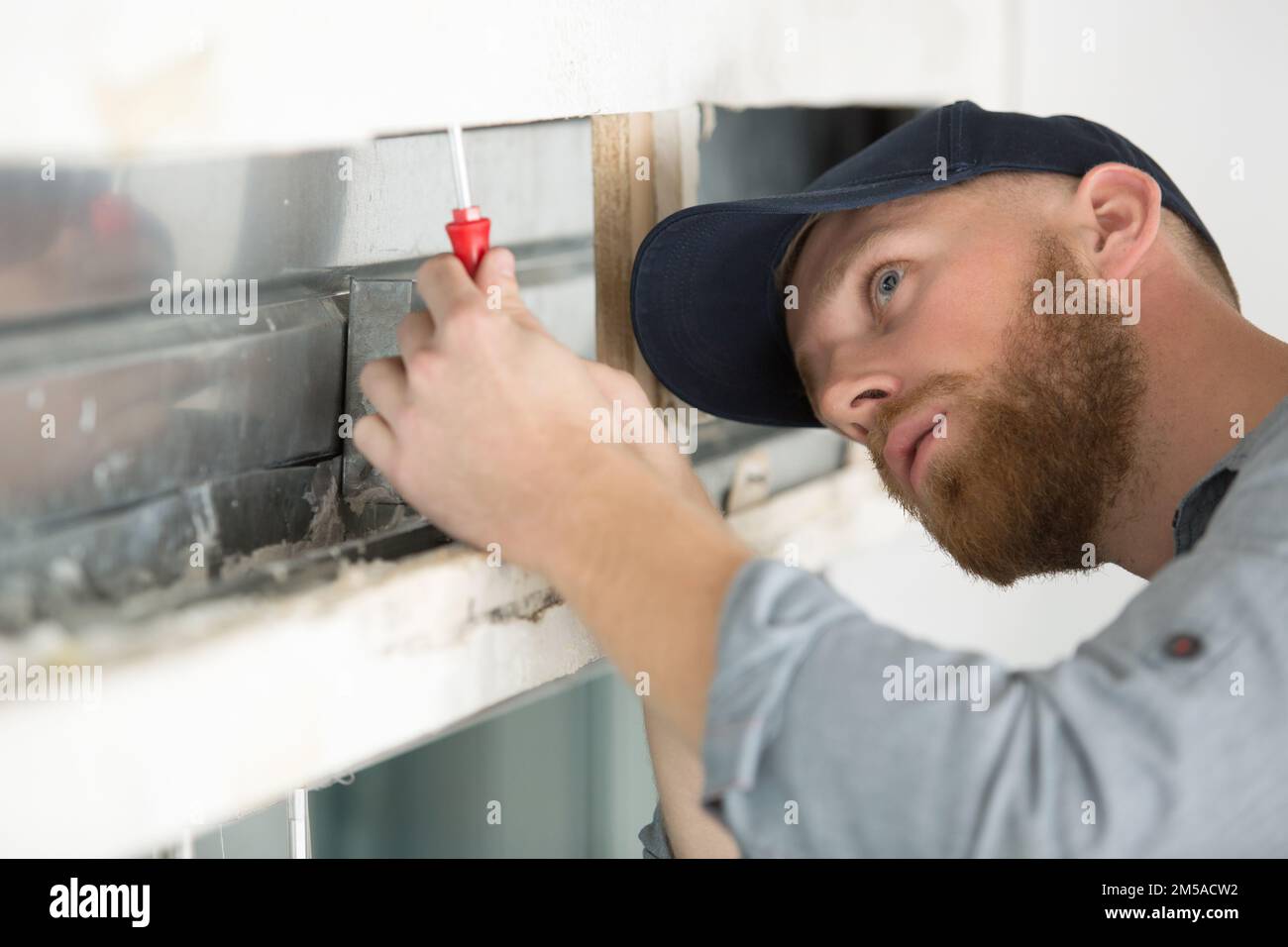 handyman fixing a window Stock Photo Alamy