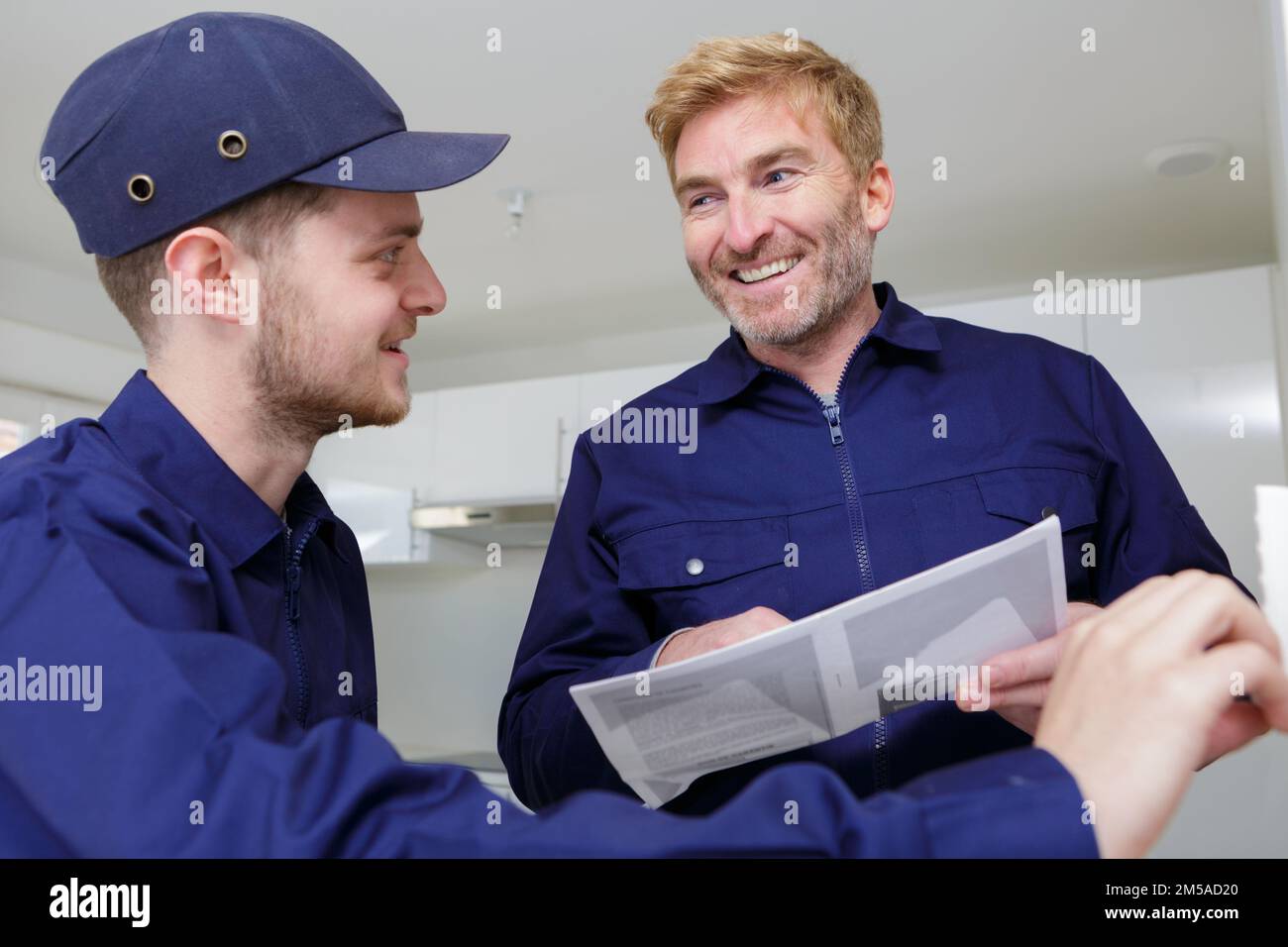 craftsman and young apprentice working together Stock Photo
