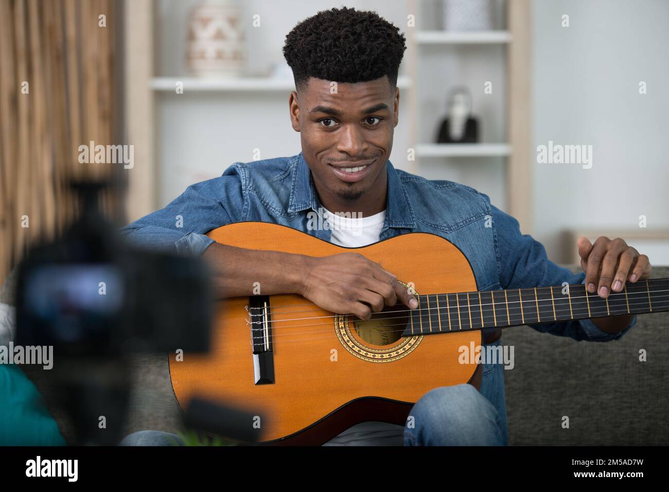 young guitar player recording video for his blog Stock Photo