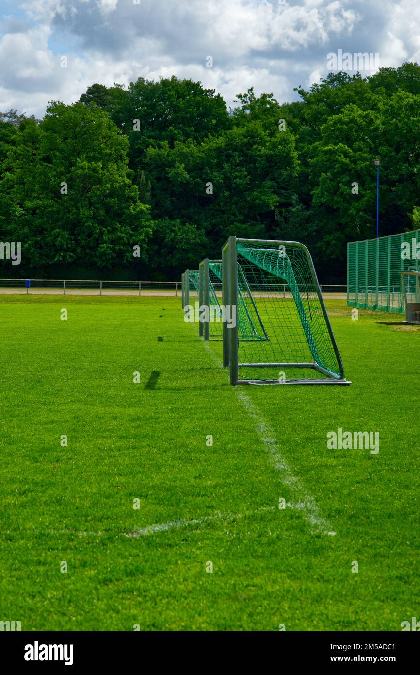 view at several small soccer goals from the sideline of a green playing