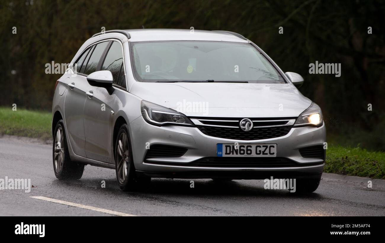 2016 silver Vauxhall Astra   driving on a wet road Stock Photo