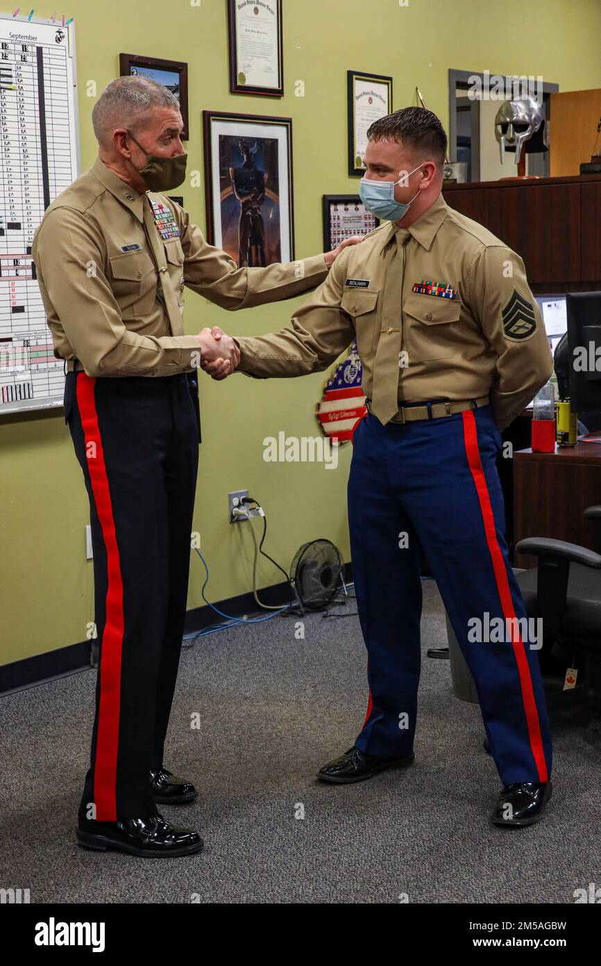 U.S. Marine Corps Maj. Gen. Jason Q. Bohm, the Commanding General of Marine Corps Recruiting Command (MCRC), congratulated SSgt. Jeremy C. Benjamin, the Pool program coordinator of Recruiting Station (RS) Lansing for his hard work and dedication in Lansing, Michigan, Feb. 16, 2022. RS Lansing is one of eight RS' under the 4th Marine Corps District and is responsible of the procurement of qualified individuals, officer and enlisted, in the United States Marine Corps and the Marine Corps Reserves. Stock Photo