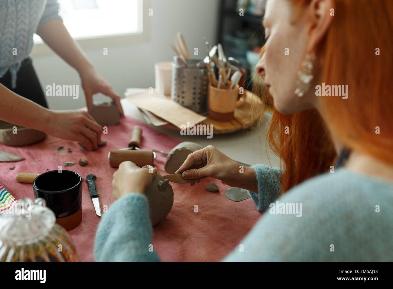 Pottery workshop class. A pottery crafts dish from a raw clay. Creating ceramics Stock Photo