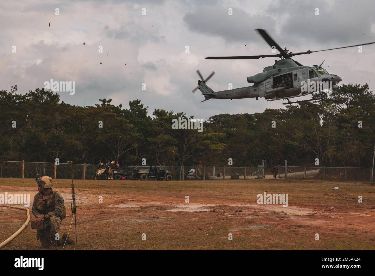 A U.S. Marine Corps UH-1Y Venom helicopter with Marine Light Attack Helicopter Squadron (HMLA) 369 takes off after being refueled during Jungle Warfare Exercise (JWX 22) at Camp Gonsalves, Okinawa, Japan, Feb. 16, 2022. JWX 22 is a large-scale field training exercise focused on leveraging the integrated capabilities of joint and allied partners to strengthen all-domain awareness, maneuvers, and fires across a distributed maritime environment. Stock Photo