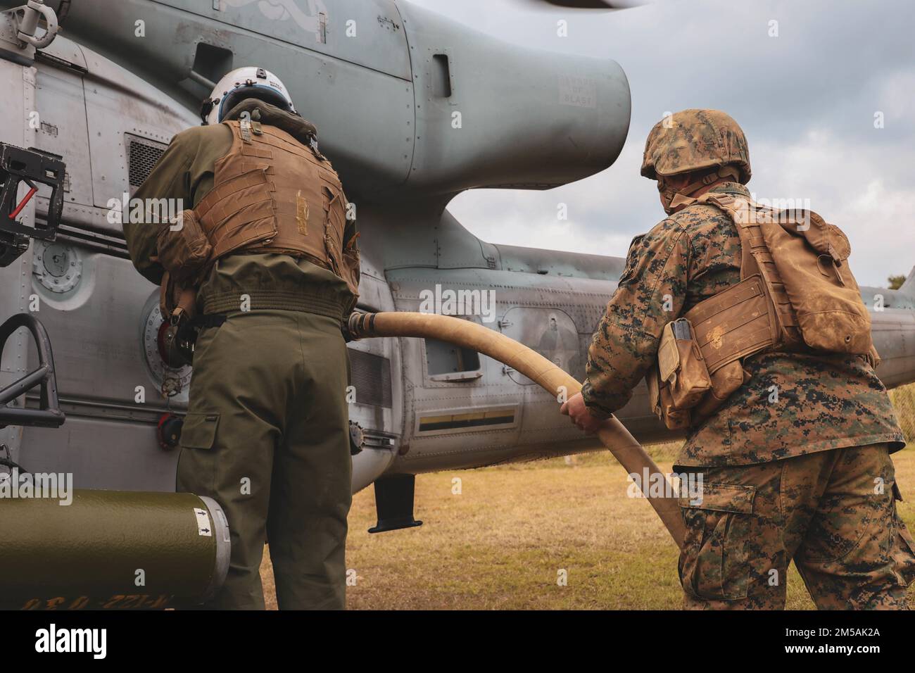 U.S. Marines with Marine Light Attack Helicopter Squadron (HMLA) 369, refuel a  U.S. Marine Corps UH-1Y Venom helicopter before takeoff during Jungle Warfare Exercise (JWX 22) at Camp Gonsalves, Okinawa, Japan, Feb. 16, 2022. JWX 22 is a large-scale field training exercise focused on leveraging the integrated capabilities of joint and allied partners to strengthen all-domain awareness, maneuvers, and fires across a distributed maritime environment. Stock Photo