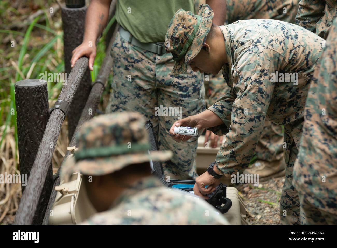 U.S. Marines with Combat Logistics Battalion 4, Combat Logistics Regiment 3, 3rd Marine Logistics Group , conduct water purification using the Platoon Water Purification System during Jungle Warfare Exercise 22, Feb. 16, 2022, Camp Gonsalves, Okinawa, Japan. JWX 22 is a large-scale field training exercise focused on leveraging the integrated capabilities of joint and allied partners to strengthen all-domain awareness, maneuver, and fires across a distributed maritime environment. Stock Photo