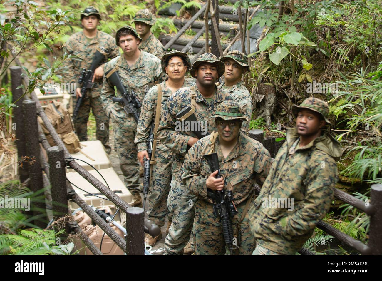 U.S. Marines with Combat Logistics Battalion 4, Combat Logistics Regiment 3, 3rd Marine Logistics Group, pose for a group picture during Jungle Warfare Exercise 22, Feb. 16, 2022, Camp Gonsalves, Okinawa, Japan. JWX 22 is a large-scale field training exercise focused on leveraging the integrated capabilities of joint and allied partners to strengthen all-domain awareness, maneuver, and fires across a distributed maritime environment. Stock Photo