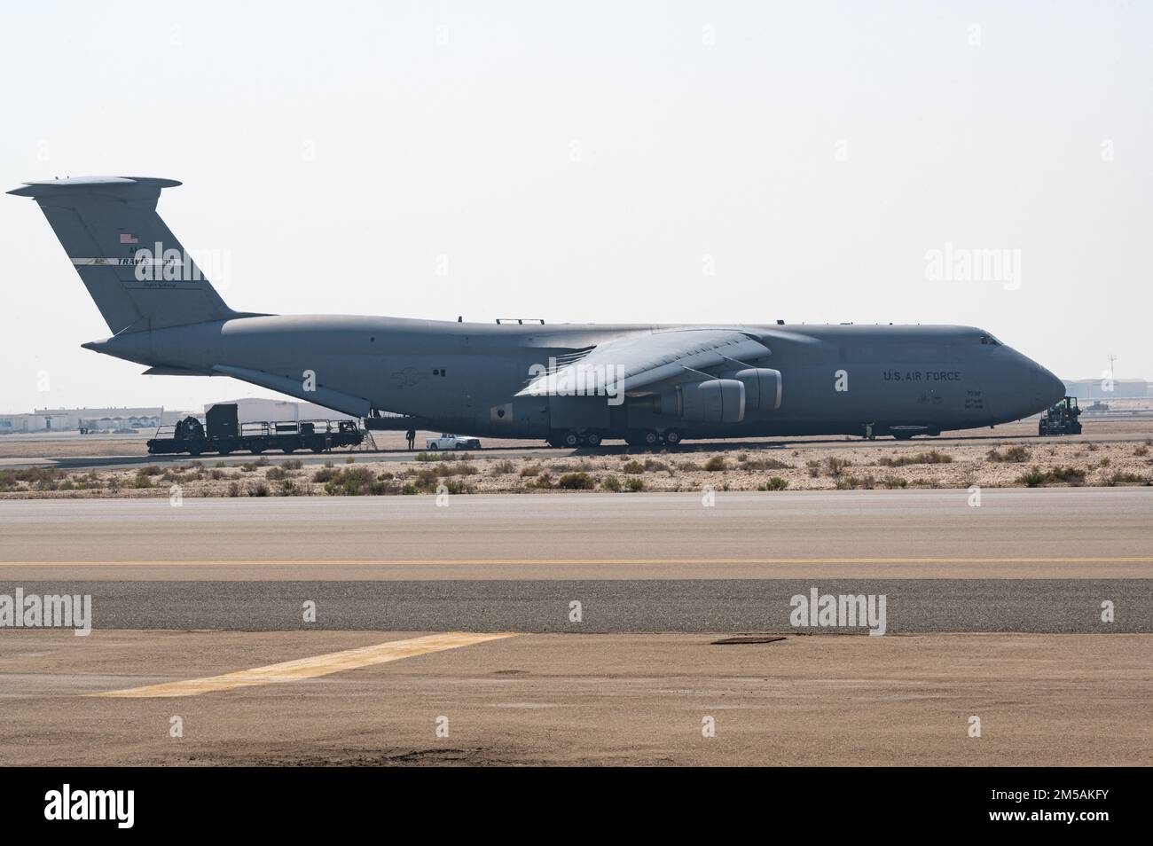 A U.S. Air Force C-5M Super Galaxy from the 60th Air Mobility Wing, Travis Air Force Base, takes on cargo at Al Dhafra Air Base, United Arab Emirates, Feb. 16, 2022. The C-5 is a strategic transport aircraft used to transport cargo and personnel for the Department of Defense. Stock Photo