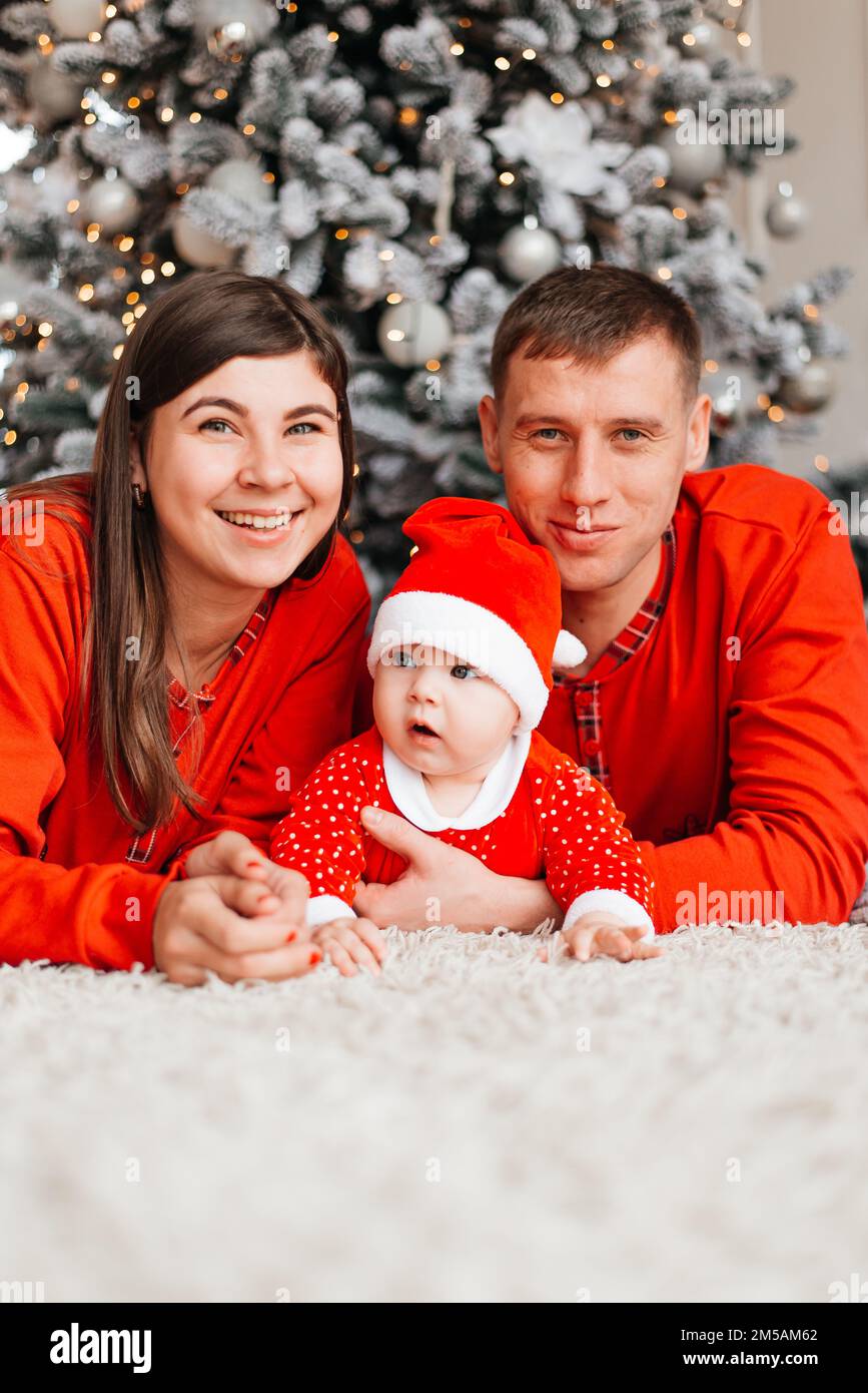 Happy family near the Christmas tree for the New Year Stock Photo