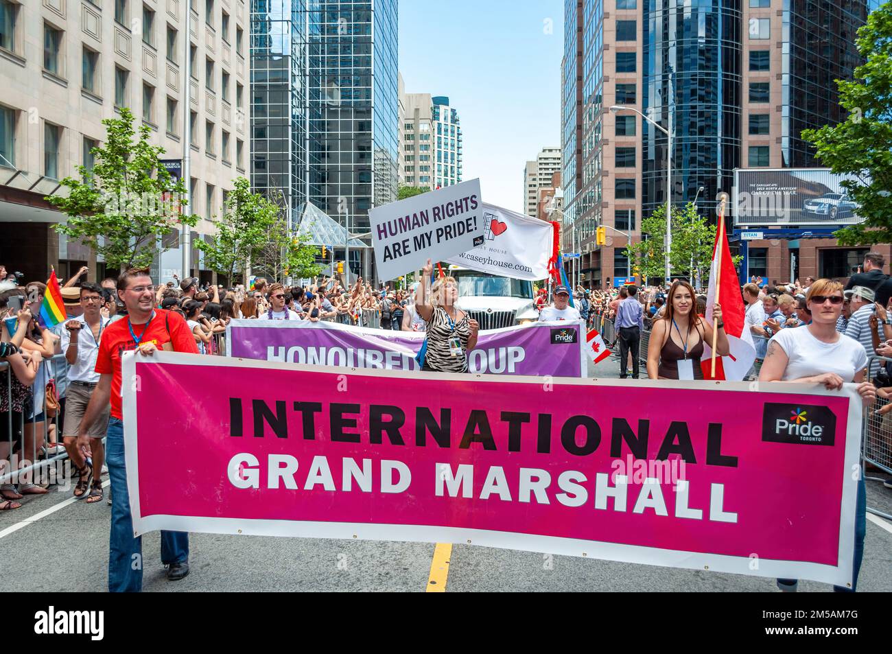 Marcela Romero, Grand Marshal, partakes in the annual LGBTQ+ celebration annual event. She carries a sign reading 'Human Rights Are My Pride.' Stock Photo