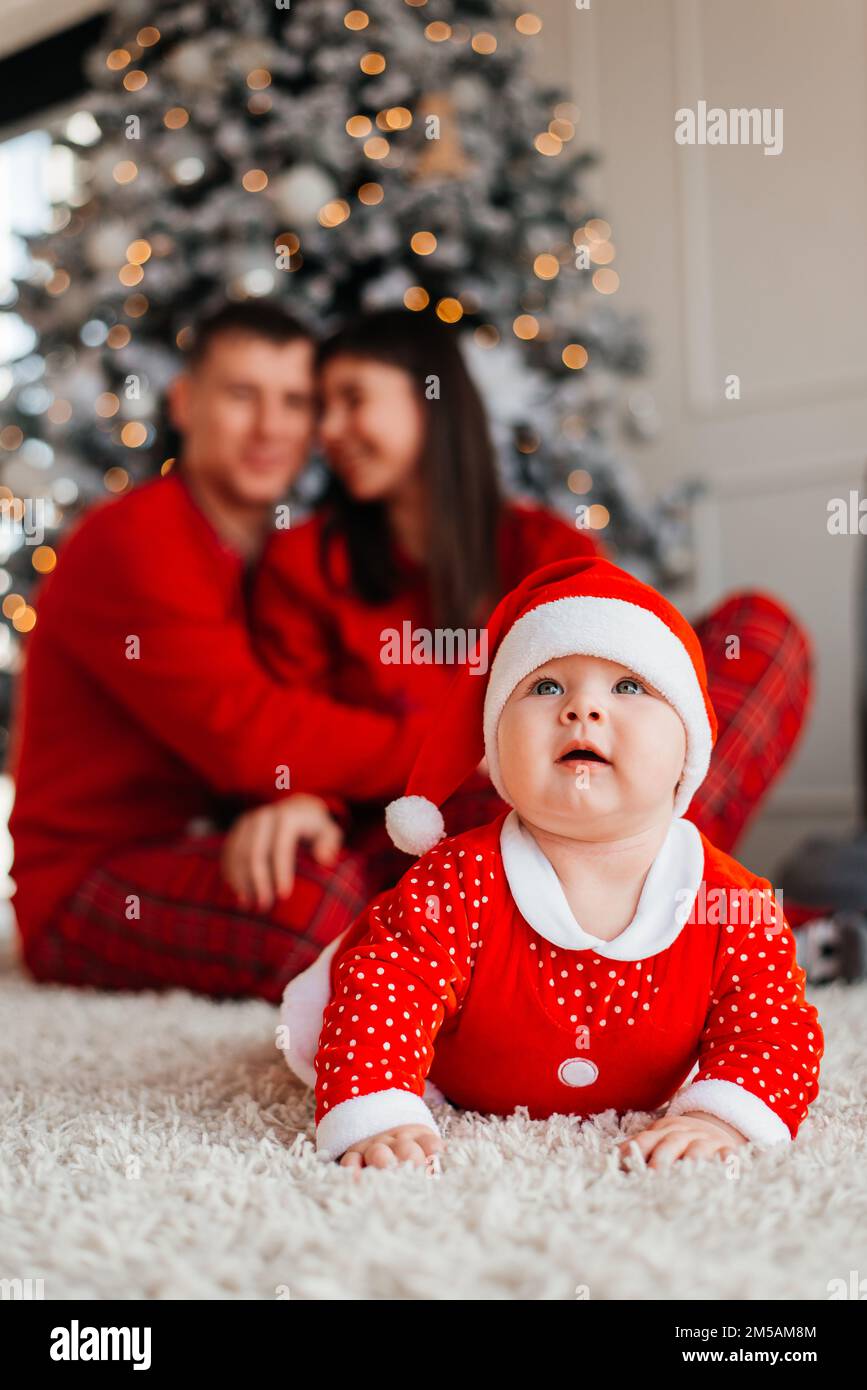 Happy family near the Christmas tree for the New Year Stock Photo