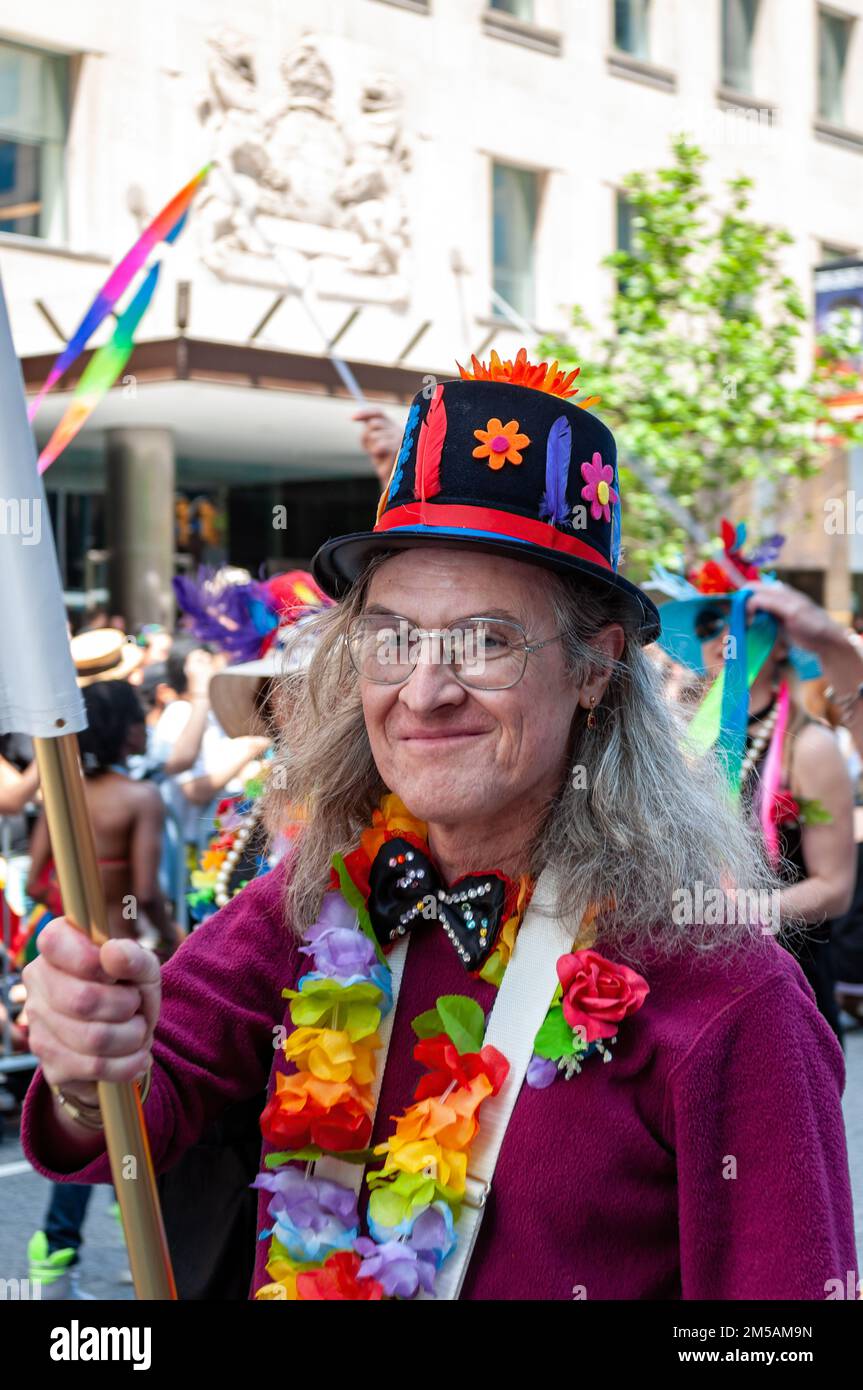 Portrait of a senior man with a raibow color necklace marching in the annual celebration. The event celebrates the LGBTQ+ community. Stock Photo