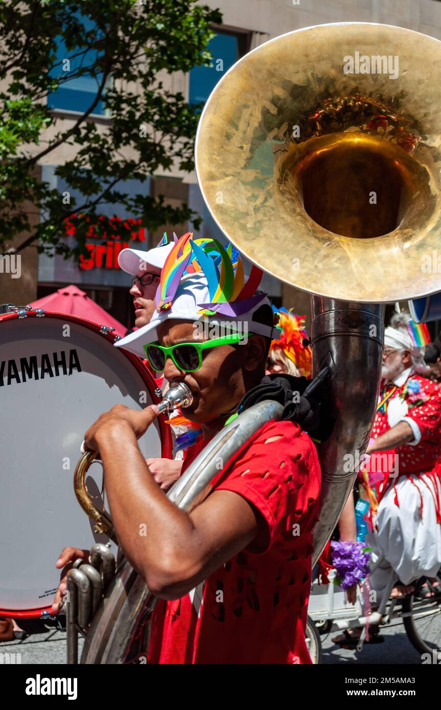A man part of a music band plays the trombone in the annual march. The event is part of the LGBTQ+ celebrations. Stock Photo