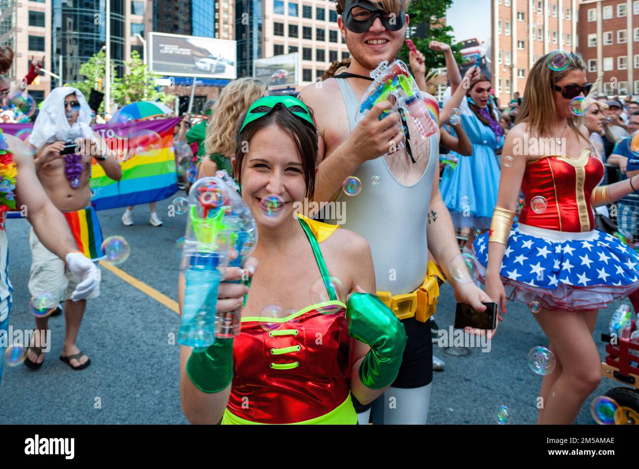 Young happy people with bubble guns march as part of the annual event. The celebration is part of the LGBTQ community. Stock Photo
