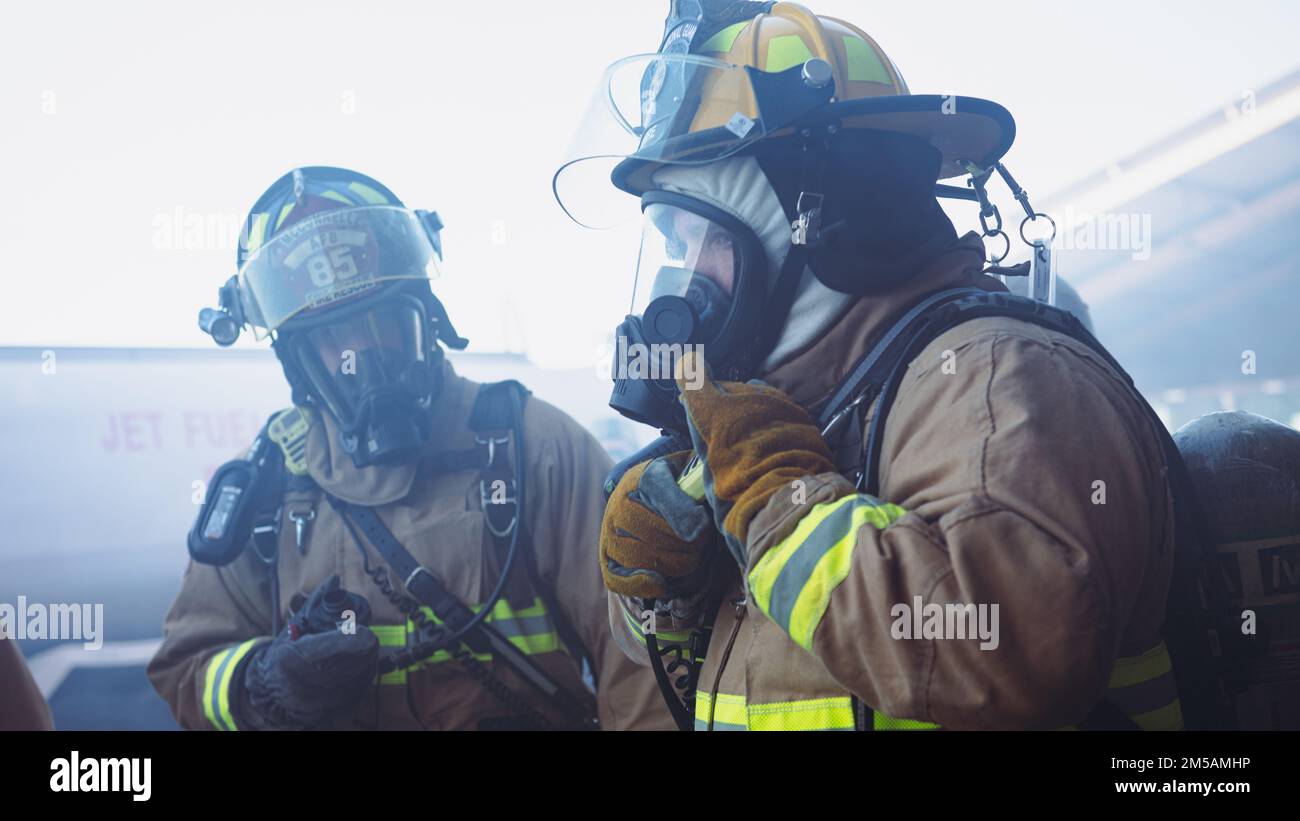 A U.S. Air Force firefighter assigned to the 379th Expeditionary Civil Engineer Squadron talks on his radio at Al Udeid Air Base, Qatar, Feb. 16, 2022. During Grand Shield 22-3, the installation’s most recent readiness training event, first responders such as security forces, medical and firefighters, enhanced their readiness posture and response efforts. Stock Photo