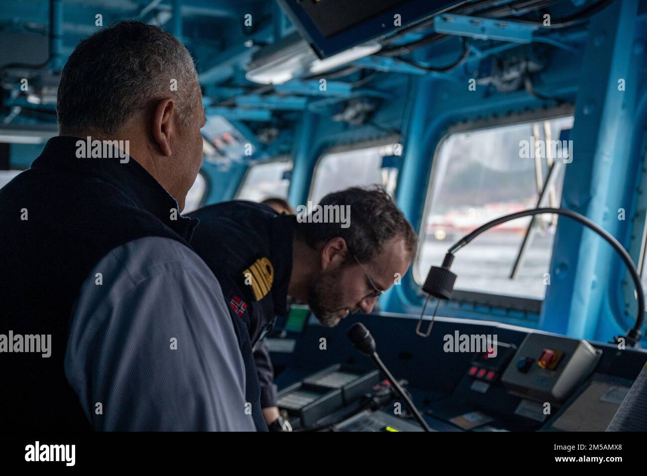BERGEN, Norway (Feb. 16, 2022) — Secretary of the Navy Carlos Del Toro prepares to address the crew of HNoMS Thor Heyerdahl (F314) over the ship’s loudspeaker with Norwegian Cmdr. Lars Ole Høknes, commanding officer of Heyerdahl, in Bergen, Norway, Feb. 16, 2022. Secretary Del Toro is in Norway to visit U.S. service members and Norwegian government leaders to reinforce existing bilateral and multilateral security relationships between the U.S. Navy and the Royal Norwegian Navy. Stock Photo