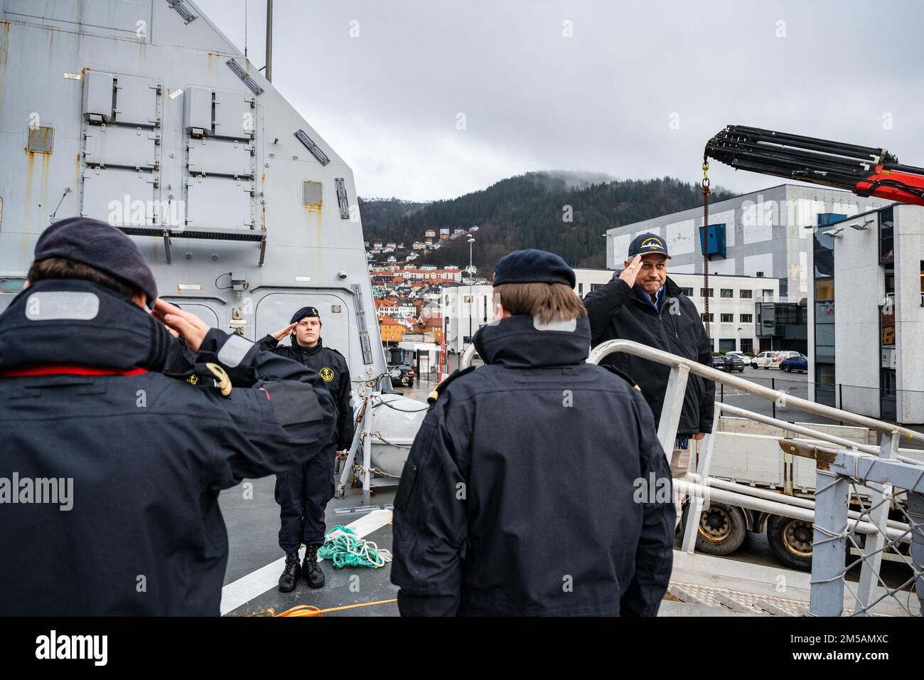 BERGEN, Norway (Feb. 16, 2022) — Secretary of the Navy Carlos Del Toro renders honors to the Norwegian flag and crew of HNoMS Thor Heyerdahl (F314), in Bergen, Norway, Feb. 16, 2022. Secretary Del Toro is in Norway to visit U.S. service members and Norwegian government leaders to reinforce existing bilateral and multilateral security relationships between the U.S. Navy and the Royal Norwegian Navy. Stock Photo