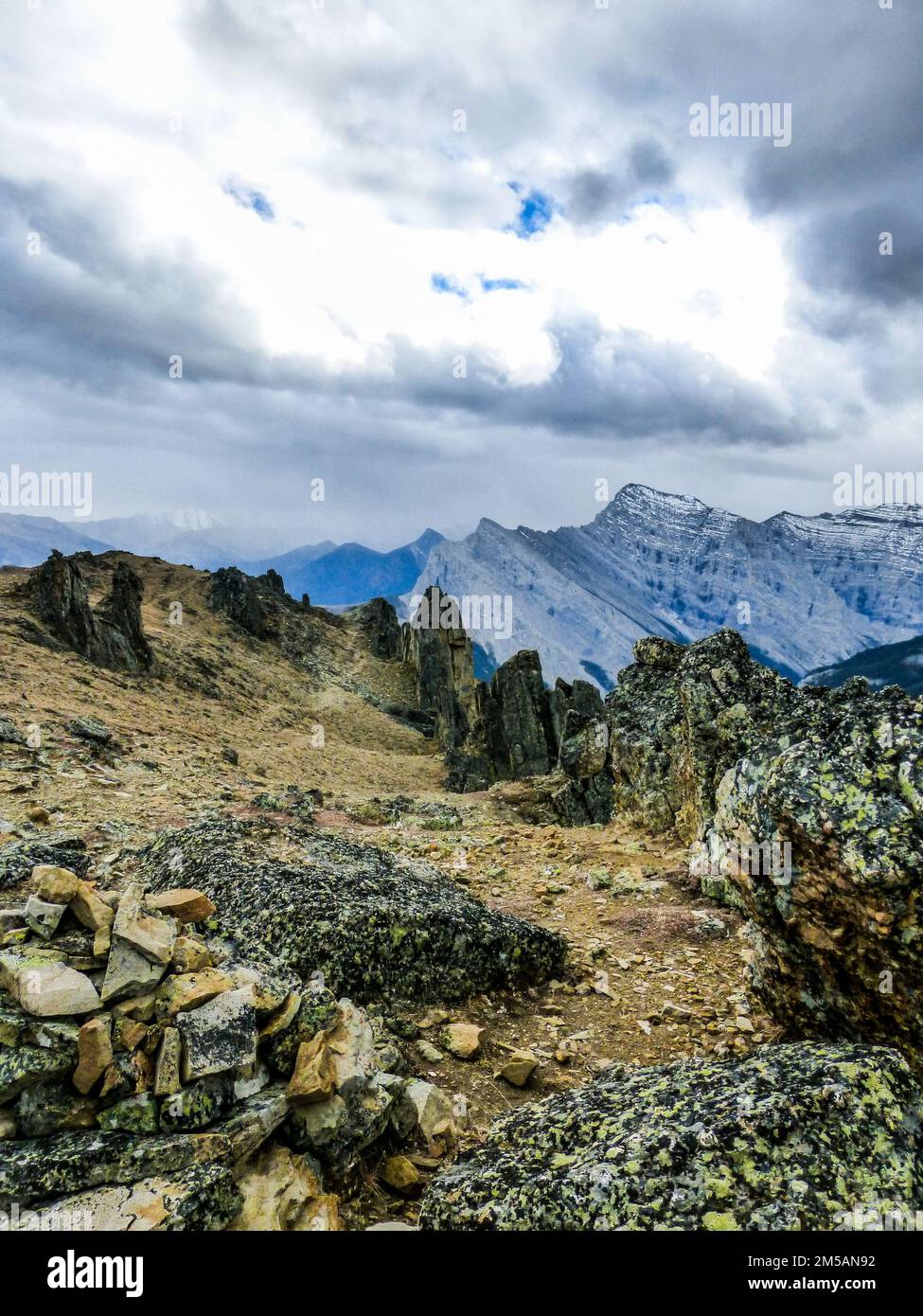 A beautiful vertical view of rocky mountain under the cloudy sky Stock ...