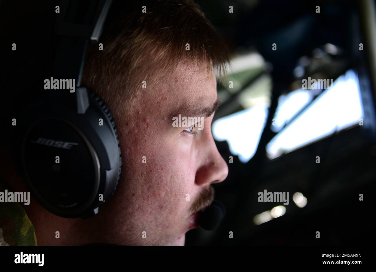 U.S. Air Force Airman 1st Class Ayden Geilinger, 50th Expeditionary Air Refueling Squadron in-flight refueling specialist, prepares to refuel an aircraft over Southwest Asia, Feb. 16, 2022. Refueling specialists need steady hands and nerves to successfully complete aerial refueling missions. Stock Photo