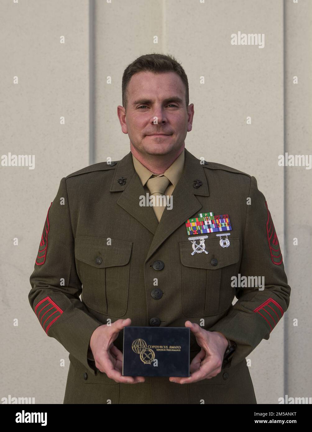 U.S. Marine Corps Master Sgt. Zachary Williams, a ground electronics systems maintenance Marine with the 15th Marine Expeditionary Unit, poses for a photo after receiving the 2022 Copernicus Award during the Armed Forces Communications and Electronics Association Western Conference and Exposition in San Diego, California, Feb. 16, 2022. The Copernicus Award honors recipients for their consistent and superior performance in their command, control, communications, computers and intelligence (C4I)/ information technology-related job fields. Stock Photo