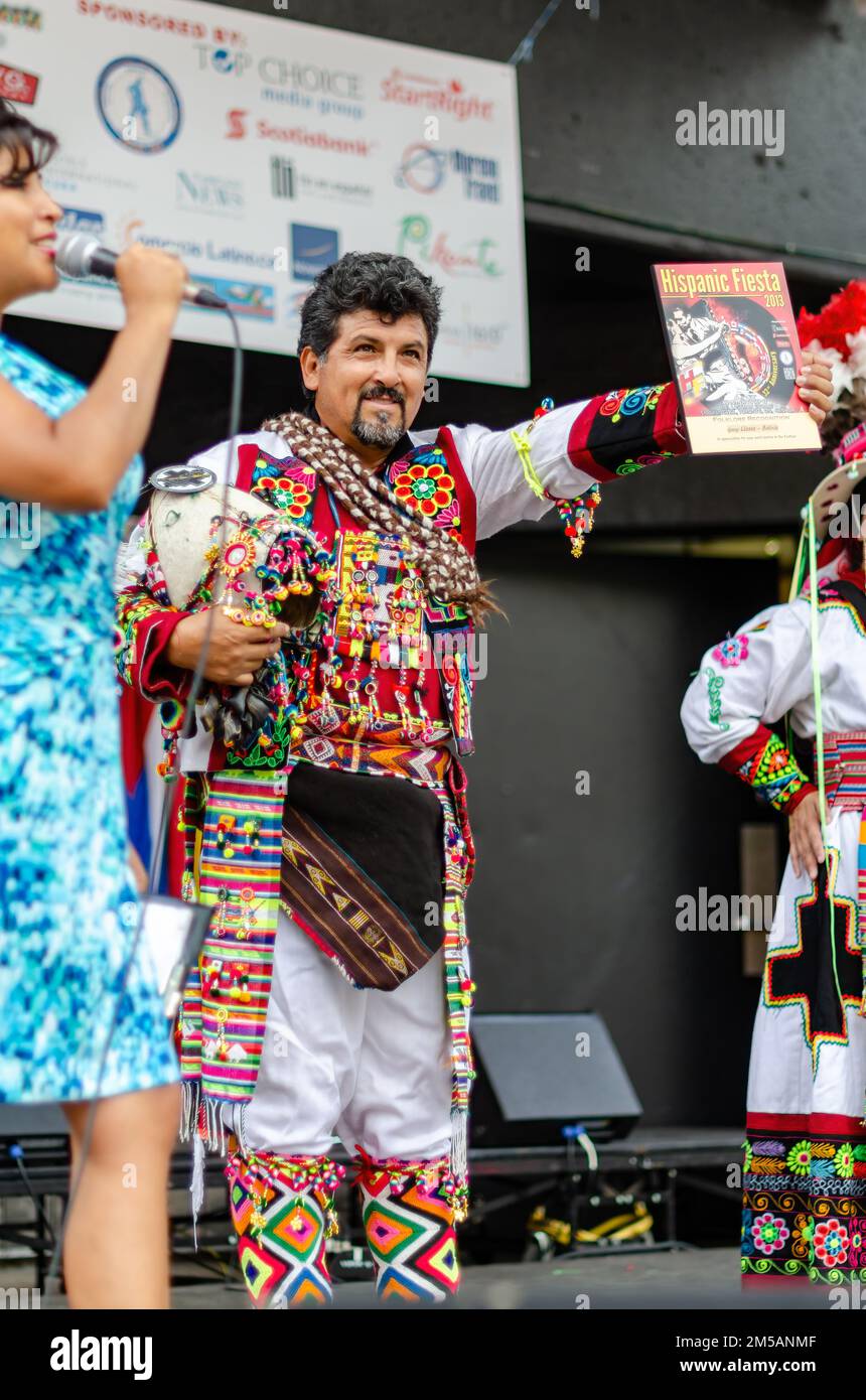 A member of the Grupo Llasas, Bolivia receives an award after their live performance. The annual event is held in Mel Lastman square. Stock Photo