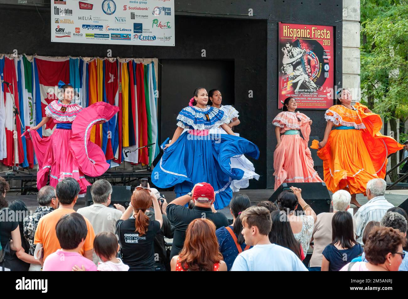 A traditional dance group performs in the stage as the general public enjoys the performance. The annual event is held in Mel Lastman square. Stock Photo