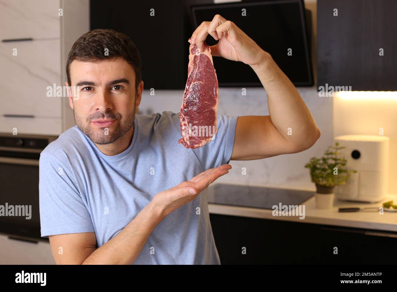 Meat lover showing a delicious raw steak Stock Photo