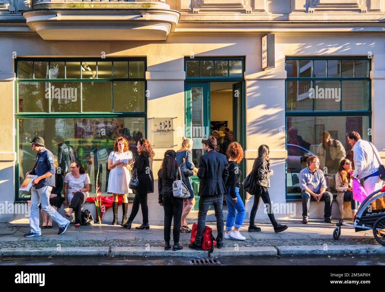 Berlin Mitte, galery opening, people standing in front of big windows Stock Photo