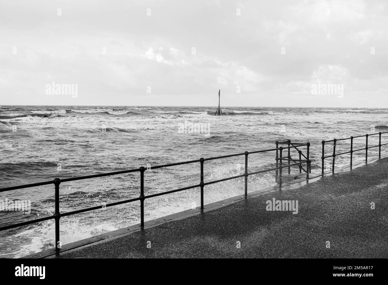 Waves around the tide marker off Crosby beach captured in monochrome at