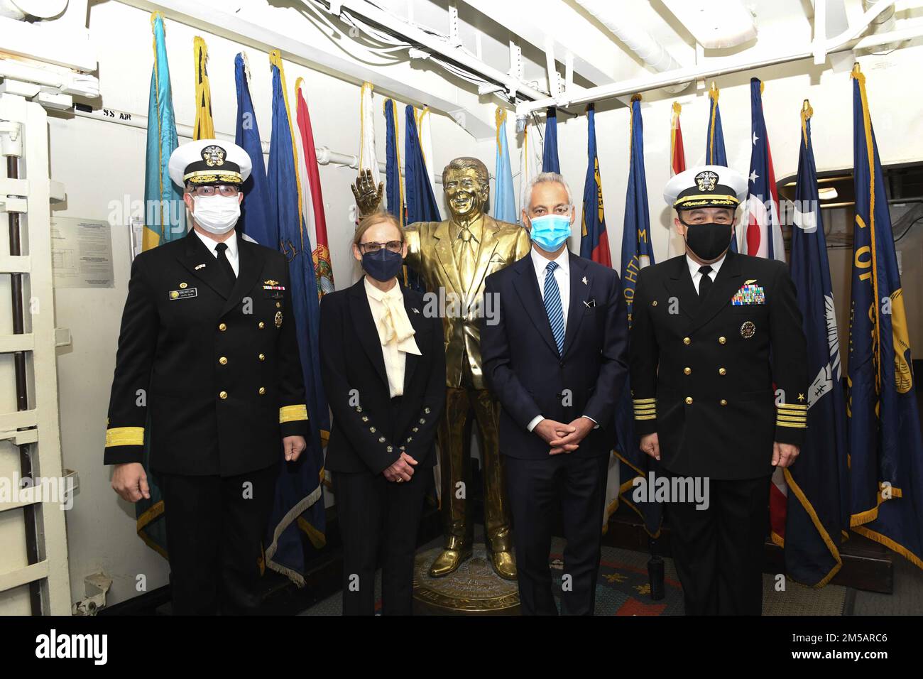 YOKOSUKA - 220217-N-ON904-1419 (Feb. 17, 2022) From left, Rear Adm. Carl Lahti, Commander, Naval Forces Japan, Navy Region, Ms. Amy Rule, U.S. Ambassador to Japan, Rahm Emanuel, and Capt. Fred Goldhammer, USS Ronald Reagan (CVN 76) commanding officer, on the ceremonial quarterdeck of Reagan. Emanuel is visiting Yokosuka to mark the importance of the bilateral partnership between the U.S. and Japan. Stock Photo